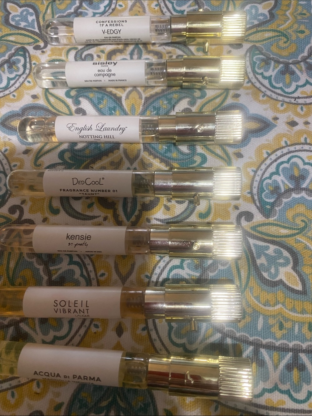 Sisley sample perfume vials with gold caps — clear